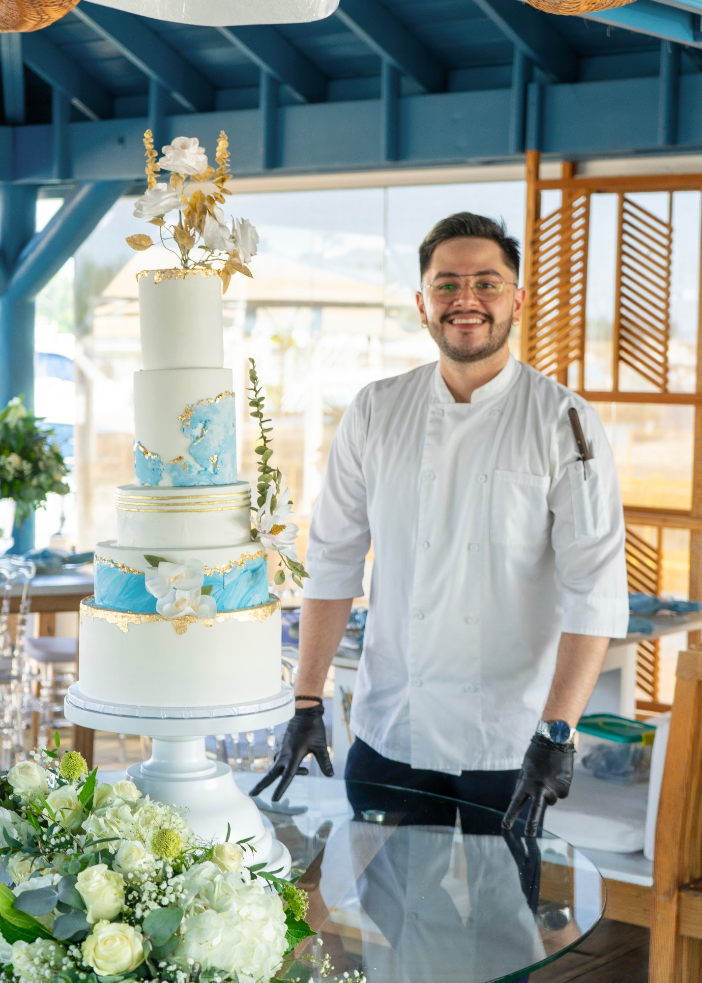 Frank González with five-tier blue marble and gold leaf wedding cake — Juan Dolio, Dominican Republic